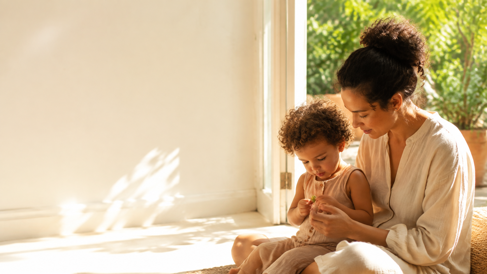 A parent and young child sharing a calm moment together in a sunlit home